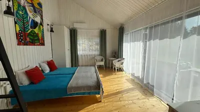 a bedroom with a bed and a table in it at Dom w Starym Sadzie z basenem i sauną - Beskid Wyspowy in Nowe Rybie