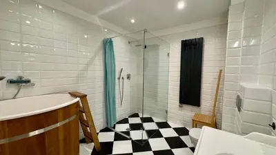 a bathroom with a black and white checkered floor at Dom w Starym Sadzie z basenem i sauną - Beskid Wyspowy in Nowe Rybie