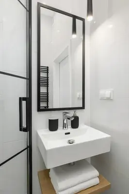 a bathroom with a white sink and a mirror at Balcony Apartment - Kazimierz- Starowiślna 41 in Kraków