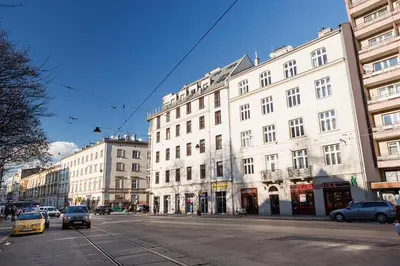 a city street with cars parked in front of buildings at Studio for two - Starowiślna 54 in Kraków