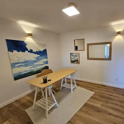 a room with a wooden table and a painting on the wall at Casa Viento in Stryszawa
