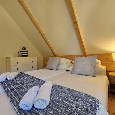 two beds sitting next to each other in a room at Casa Viento in Stryszawa