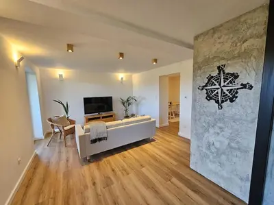 a living room with a couch and a tv at Casa Viento in Stryszawa