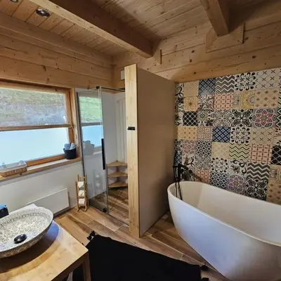 a bathroom with a white tub and a sink at Casa Viento in Stryszawa