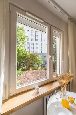a window in a bathroom with a sink at Kraków Czyżyny - Terrace by Rentujemy in Kraków