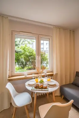 a living room with a table with food on it at Kraków Czyżyny - Terrace by Rentujemy in Kraków