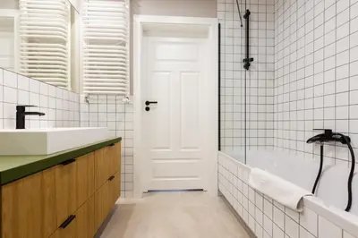 a bathroom with a white tub and a sink at Przestronny apartament Vermelo Parking in Kraków