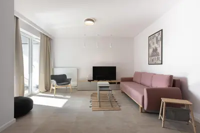 a living room with a couch and a tv at Przestronny apartament Vermelo Parking in Kraków
