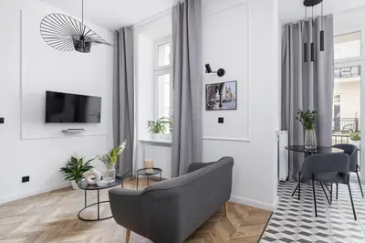a living room with a couch and a tv at Kazimierz - Balcony Apartment - 41 Starowislna Street in Kraków