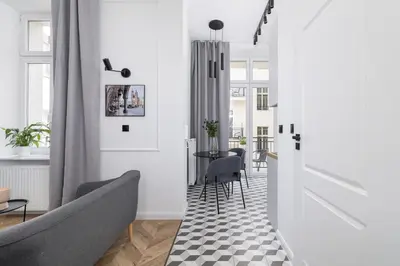 a living room with a couch and a table at Kazimierz - Balcony Apartment - 41 Starowislna Street in Kraków
