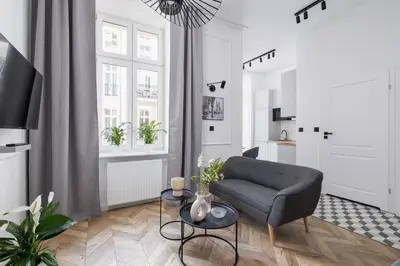 a living room with a couch and a table at Kazimierz - Balcony Apartment - 41 Starowislna Street in Kraków