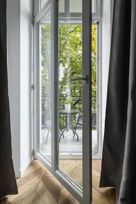 a sliding glass door leading to a patio at Apartment with Balcony - 41 Starowislna Street in Kraków