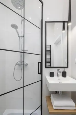 a white bathroom with a sink and a mirror at Apartment with Balcony - 41 Starowislna Street in Kraków