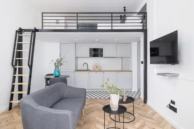 a living room with a loft bed and a chair at Apartment with Balcony - 41 Starowislna Street in Kraków