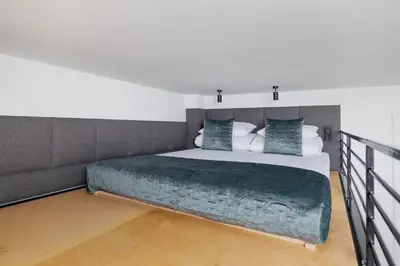a bedroom with a large bed with a green blanket at Apartment with Balcony - 41 Starowislna Street in Kraków