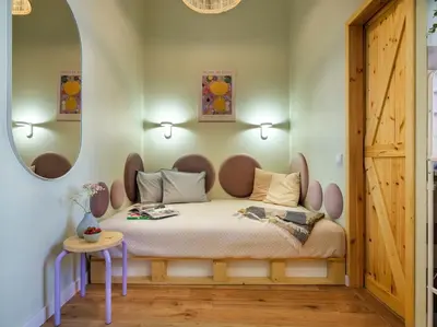 a bedroom with a bed with a round mirror at Crocus narrow studio / Kochanowskiego in Kraków