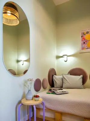 a bedroom with a bed with a round mirror at Crocus narrow studio / Kochanowskiego in Kraków