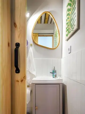 a bathroom with a sink and a mirror at Crocus narrow studio / Kochanowskiego in Kraków