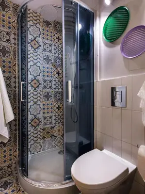 a bathroom with a shower and a toilet in it at Crocus narrow studio / Kochanowskiego in Kraków
