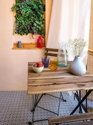 a wooden table with vases and flowers on it at Crocus narrow studio / Kochanowskiego in Kraków