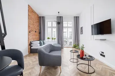 a living room with a couch and a tv at Apartment with Balcony - Starowiślna 41 in Kraków
