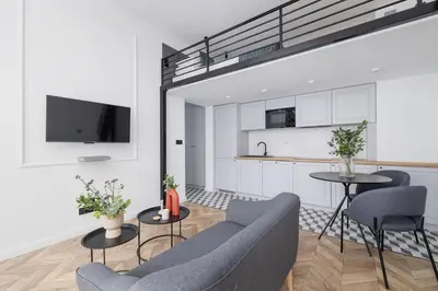 a living room with a couch and a table with chairs at Apartment with Balcony - Starowiślna 41 in Kraków