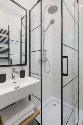 a bathroom with a shower and a white sink at Apartment with Balcony - Starowiślna 41 in Kraków