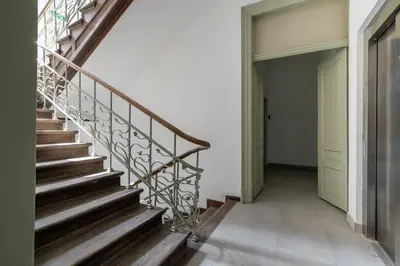 a wooden staircase in a house with a door at Apartment with Balcony - Starowiślna 41 in Kraków