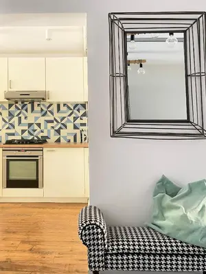 a living room with a mirror and a couch at Charming Apartment with balcony, Jewish District in Kraków