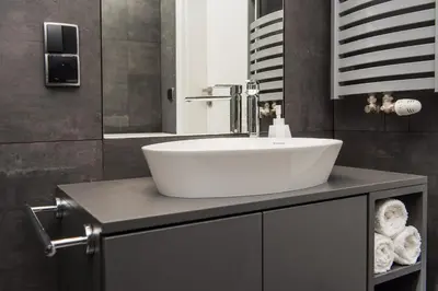 a bathroom with a white sink on a counter at Charming Apartment with balcony, Jewish District in Kraków