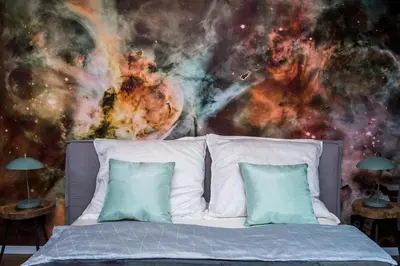 a bed in a room with a galaxy mural at Charming Apartment with balcony, Jewish District in Kraków
