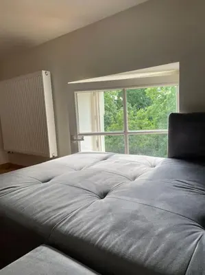 a bed in a room with a large window at Househost Apt: Gertrudy 10/43 in Kraków
