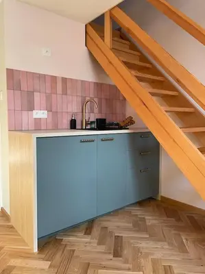 a kitchen with a sink and a staircase in a room at Househost Apt: Gertrudy 10/43 in Kraków