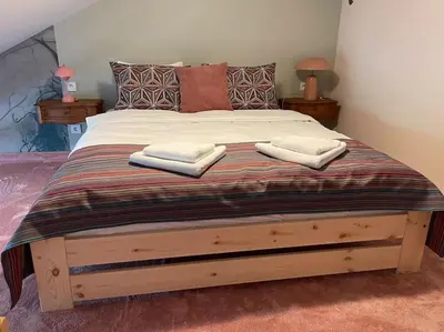 a bedroom with a large bed with two towels on it at Househost Apt: Gertrudy 10/43 in Kraków