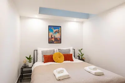 a bedroom with a bed with two towels on it at Luxe Living Kazimierz with Patio in Kraków