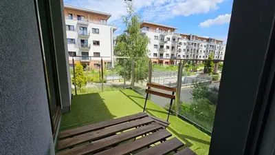 a balcony with a bench and a view of a building at Apartment Bunscha Park in Kraków