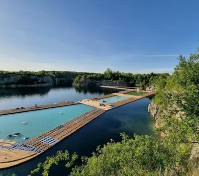 a river with a dock in the water at Apartment Bunscha Park in Kraków