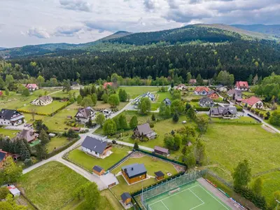 an aerial view of a small village with a tennis court at Wilczna Stodoła in Zawoja
