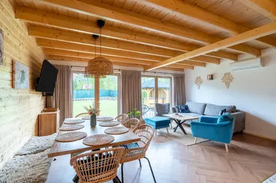 a living room with a table and chairs at Wilczna Stodoła in Zawoja