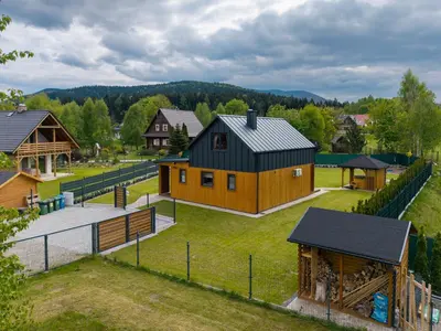 an aerial view of a farm with a barn at Wilczna Stodoła in Zawoja