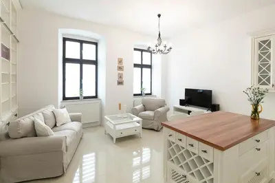 a living room with a couch and a table at Apartamenty Winnicy Kresy III in Kraków