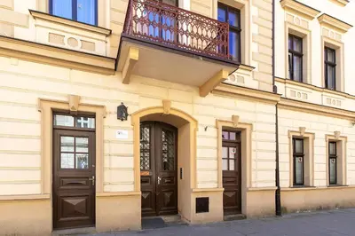 a building with two doors and a balcony at Apartamenty Winnicy Kresy III in Kraków
