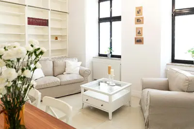 a living room with a couch and a coffee table at Apartamenty Winnicy Kresy III in Kraków