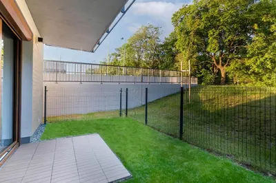 a fence in the backyard of a house at Czerwone Maki Studio with Garden by BookingHost in Kraków