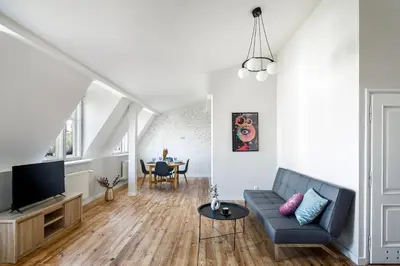 a living room with a couch and a tv at GA Apartments in Kraków