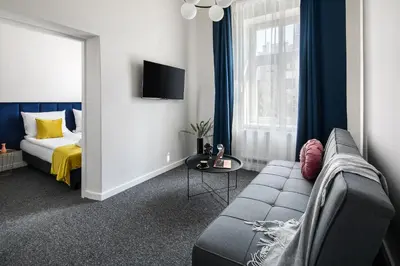 a living room with a couch and a bed at GA Apartments in Kraków