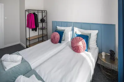 a large white bed with two pillows on it at GA Apartments in Kraków