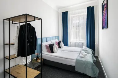 a bedroom with a bed and a window at GA Apartments in Kraków