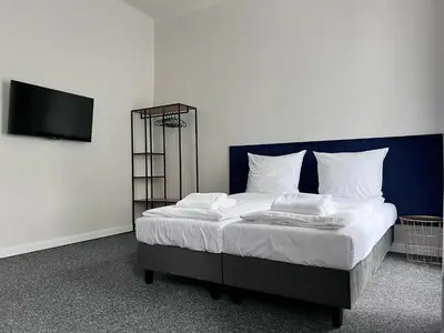 a bed with white sheets and pillows in a room at GA Apartments in Kraków