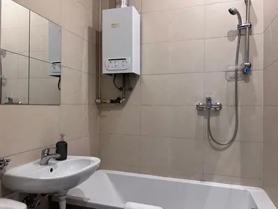 a bathroom with a shower and a sink and a bath tub at GA Apartments in Kraków